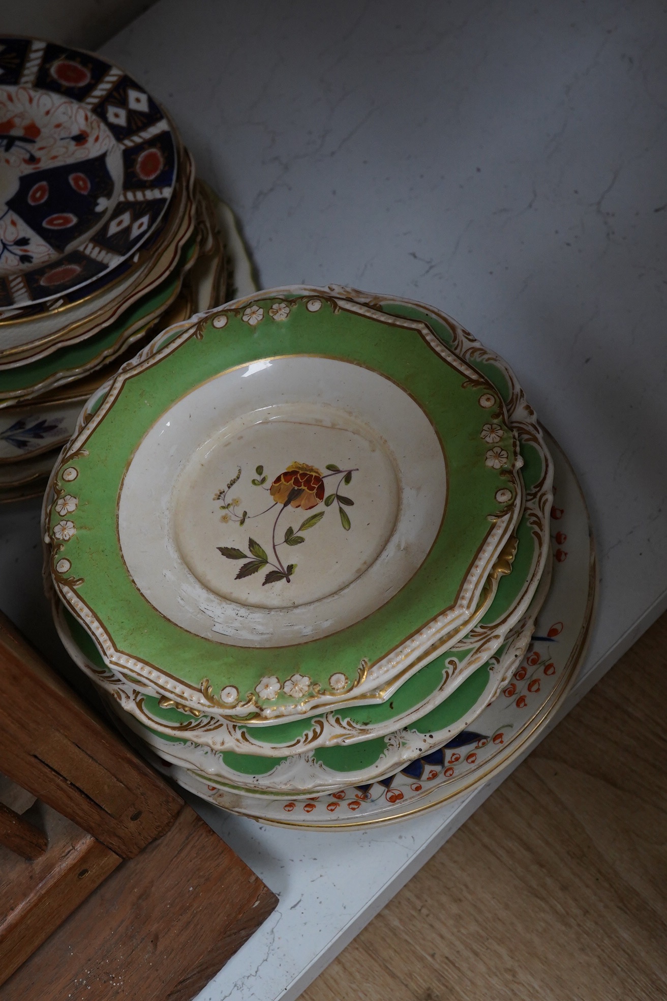 A teak plate rack with sundry antique plates. Condition - varies